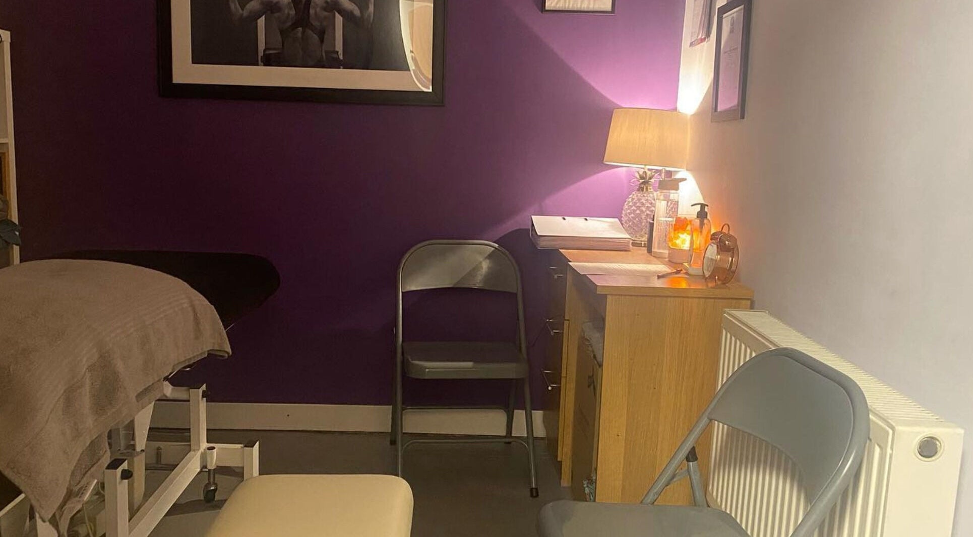 Cozy treatment room at Molly Sports Massage at Locker 27, Addlestone, England, GB, featuring a massage table.