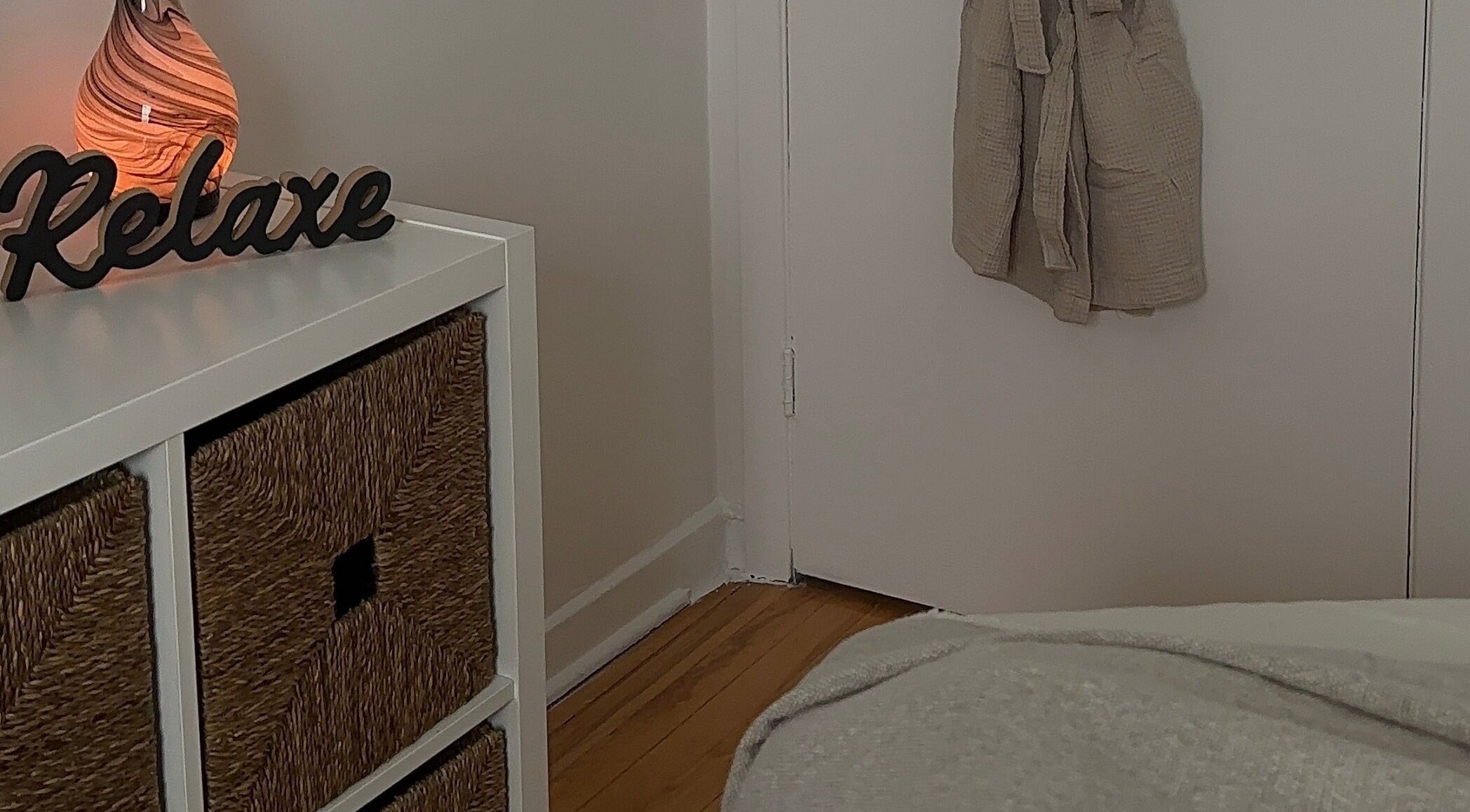 Cozy corner with 'Relax' sign at Art by Douja, Montréal, Québec, CA promoting tranquility.