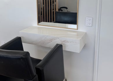 Elegant styling station at Amelia Maeve Hair, Blenheim, Marlborough Region, NZ with a modern chair and mirror.