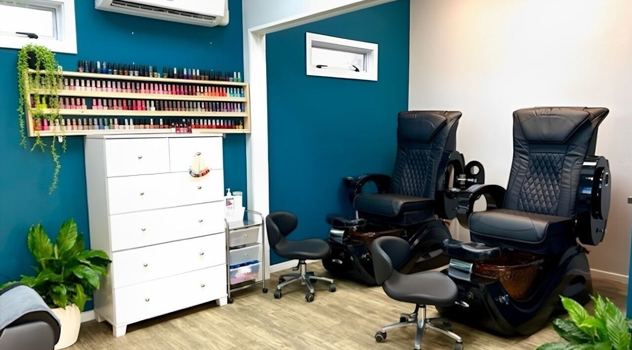 Relaxing nail salon area at Eve Nail & Beauty - Kaiapoi, featuring plush chairs and vibrant polish selection.