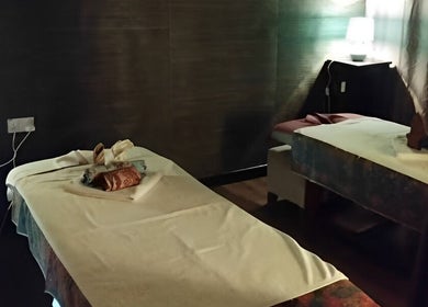 Relaxing massage room at Touch of Wellness Spa, Kota Kinabalu, Sabah, MY with dim lighting and warm ambiance.