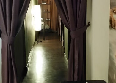Serene corridor at Touch of Wellness Spa, Kota Kinabalu, Sabah, MY with dim lighting and elegant curtains.