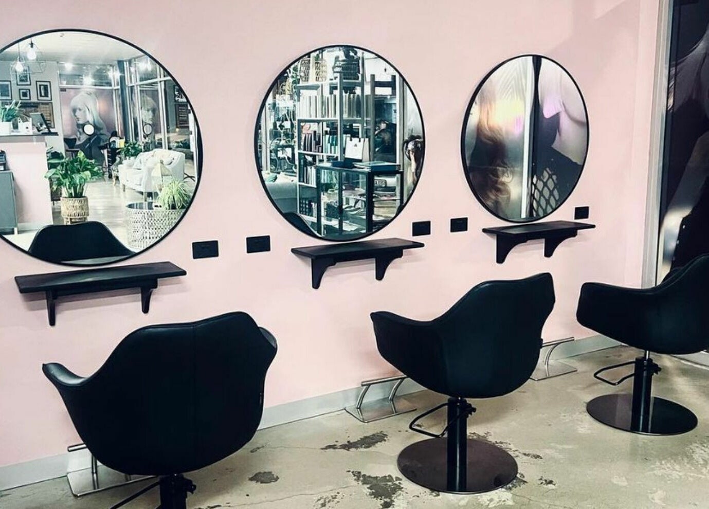 Modern salon interior of Longko Salon in Mawson Lakes, South Australia, AU, featuring stylish mirrors and chairs.