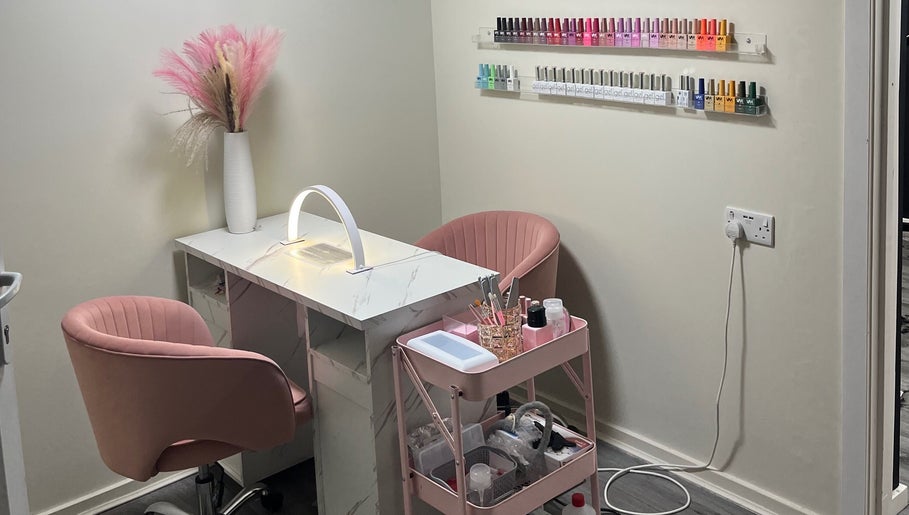 Stylish nail station at Marble Beauty Bar, Glasgow, Scotland, GB, with pink chairs and nail polish display.