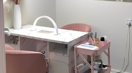 Elegant nail salon setup at Marble Beauty Bar in Glasgow, Scotland, GB with chic pink seating and marble table.