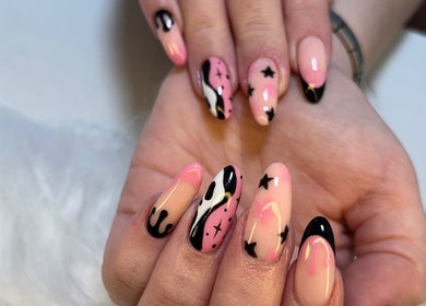 Creative nail art with pink and black celestial designs at Marble Beauty Bar, Glasgow, Scotland, GB.