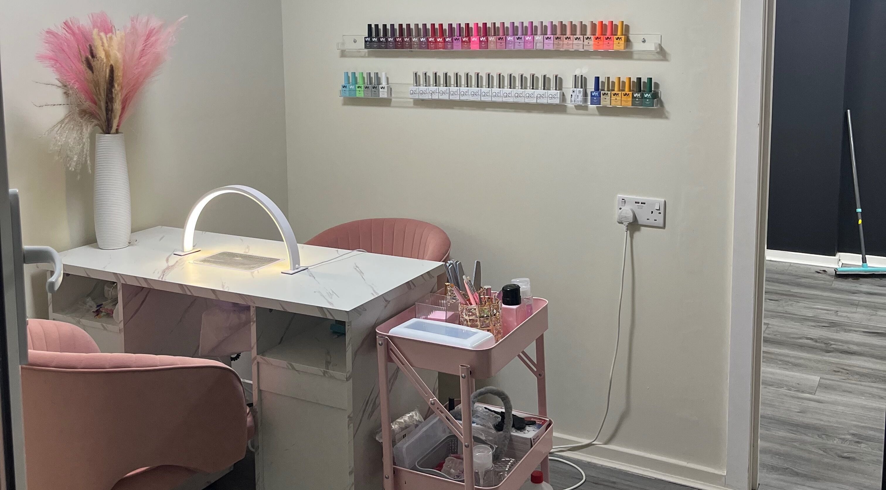 Cozy nail station at Marble Beauty Bar, Glasgow, Scotland, GB with polish display and decor.