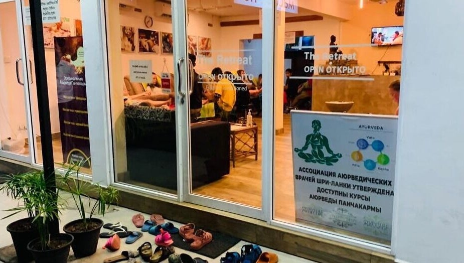 The Retreat in Hikkaduwa, Southern Province, LK, warmly lit entrance showcasing wellness services.