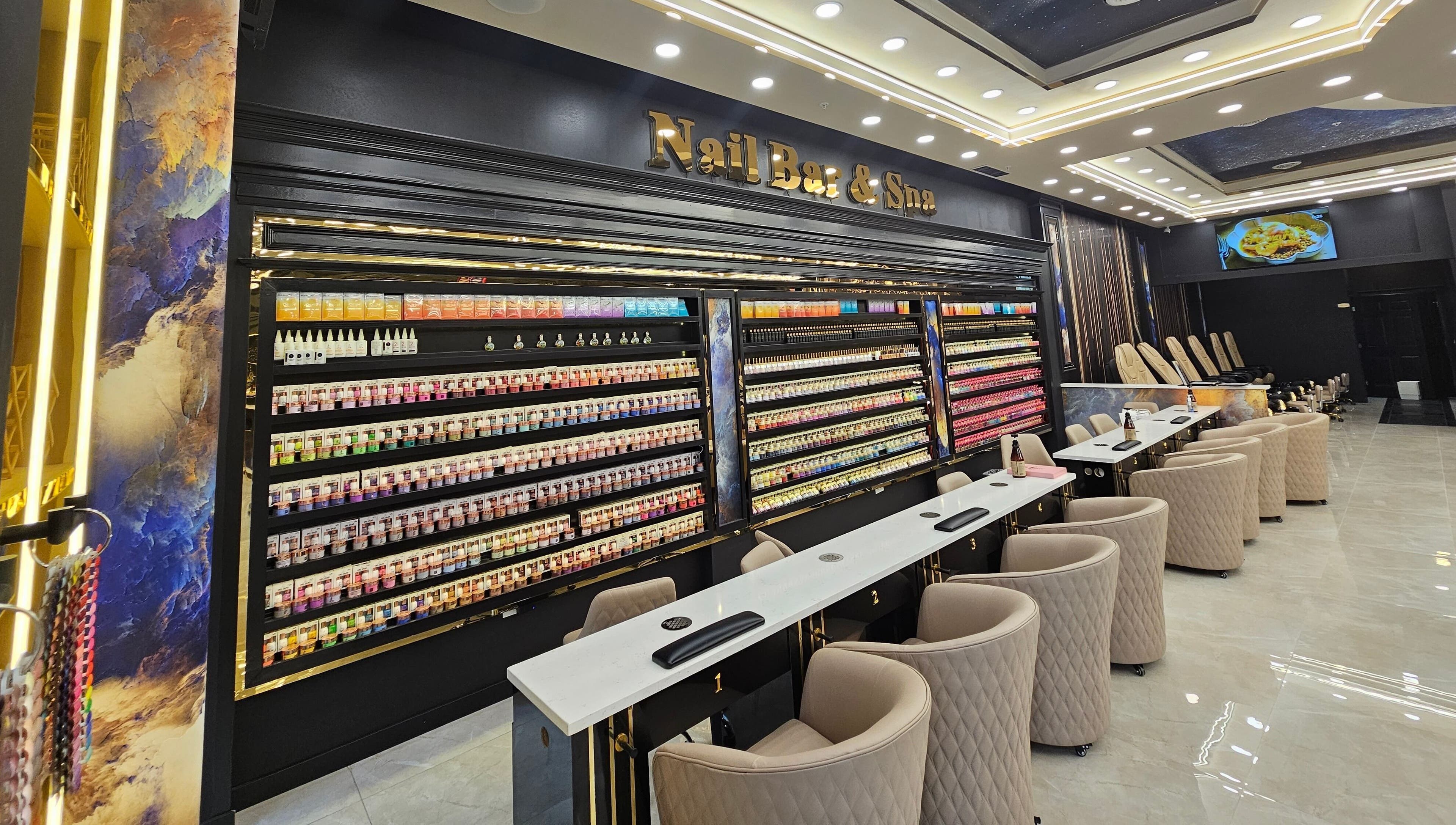 Interior of MV Nail Bar and Spa in Jeffersonville, Indiana, US showcasing nail stations and color displays.