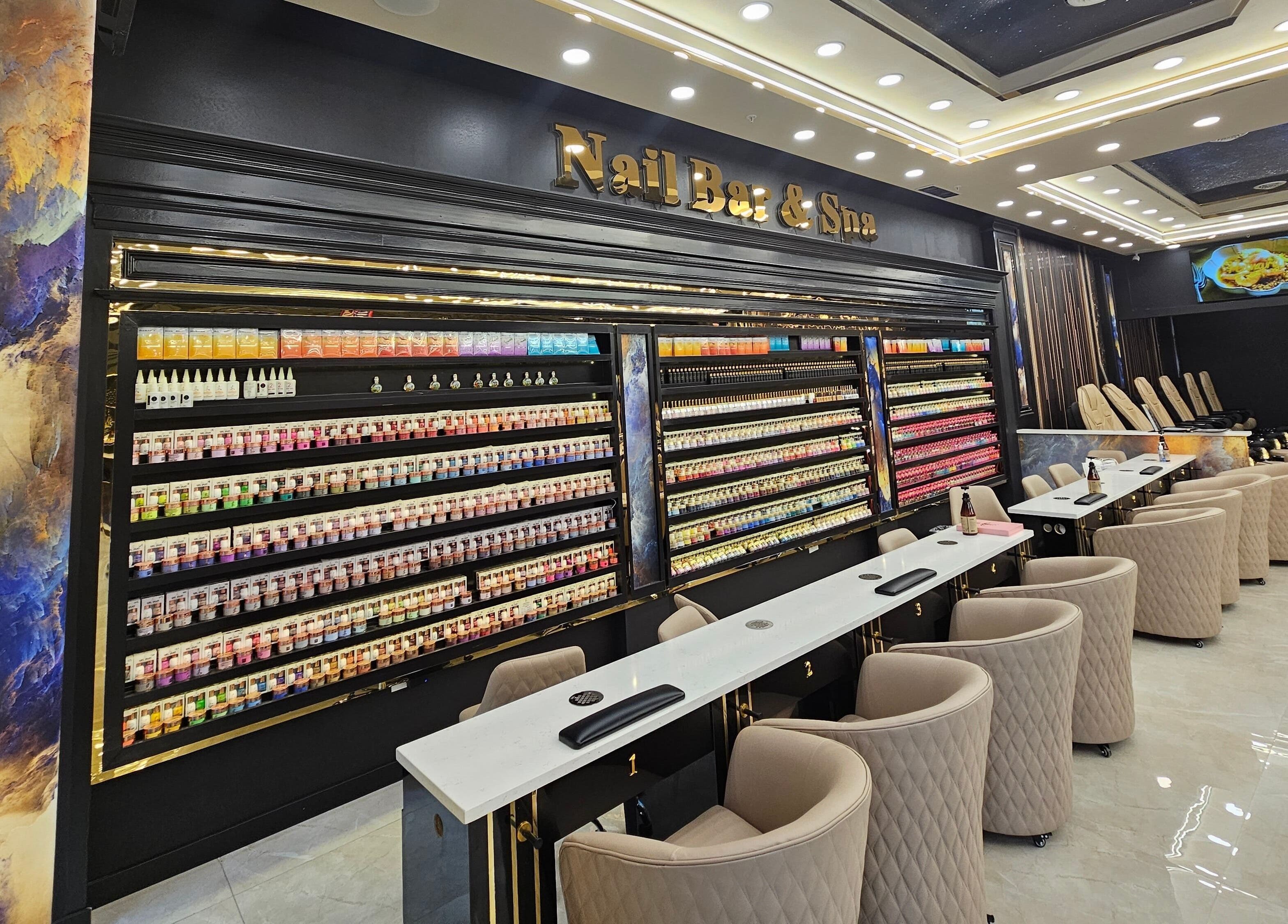 Interior of MV Nail Bar and Spa in Jeffersonville, Indiana, US showcasing nail stations and color displays.