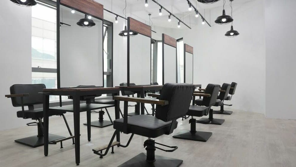 Modern salon setup at ASSORT HONG KONG, Hong Kong Island, HK, featuring sleek black chairs and mirrors.