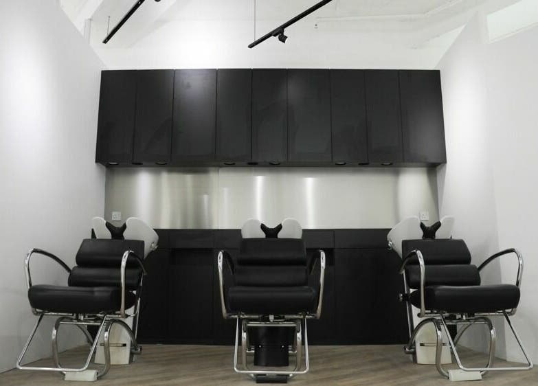 Modern salon seating at ASSORT HONG KONG on Hong Kong Island, HK, showcasing sleek black design.