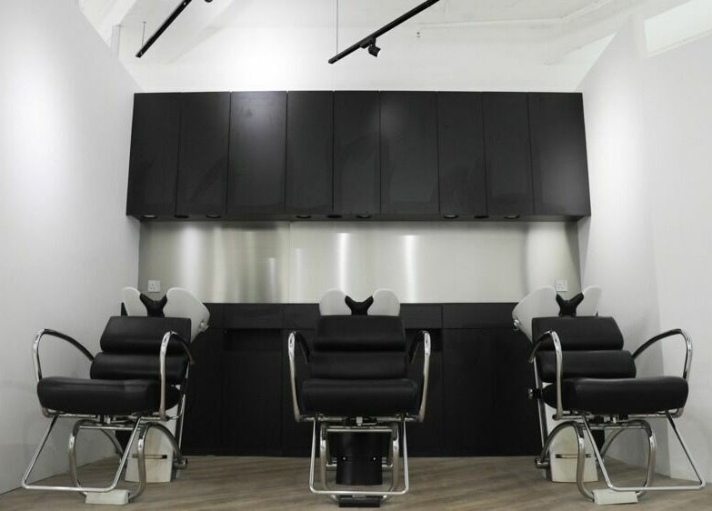 Modern salon seating at ASSORT HONG KONG on Hong Kong Island, HK, showcasing sleek black design.