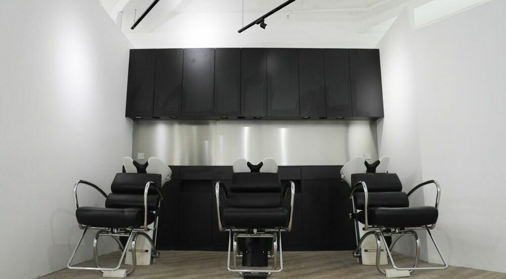 Modern salon seating at ASSORT HONG KONG on Hong Kong Island, HK, showcasing sleek black design.