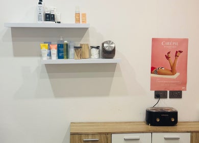 The Wax Lounge Mauritius in Port Louis features neatly arranged beauty products on shelves for a cozy, inviting ambiance.