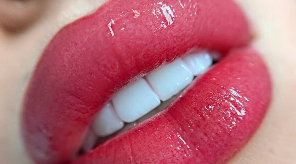 Close-up of glossy red lips at Beauty By Darya | صالون داريا, الدوحة, بلدية الضعاين, QA.