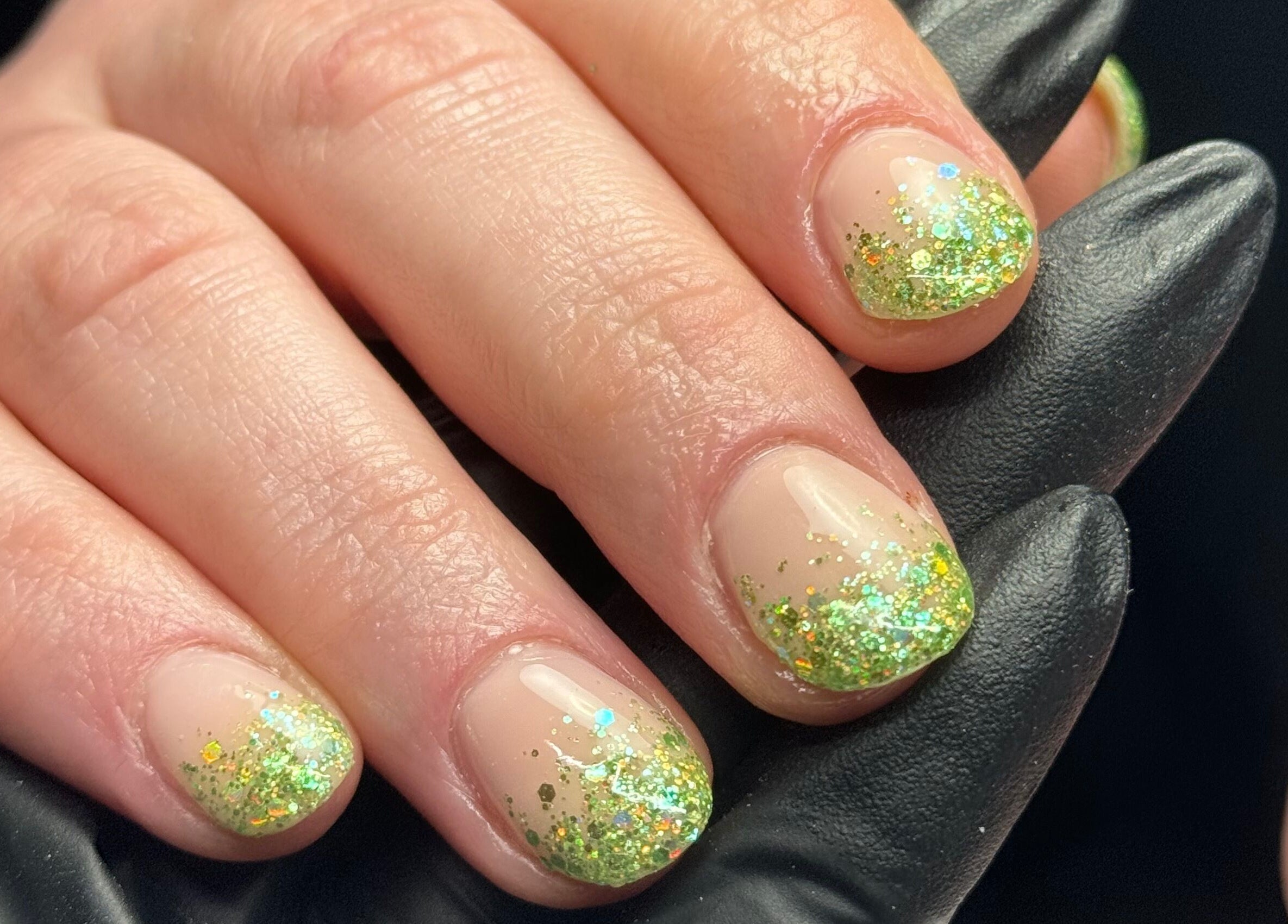 Glittering green nail art at Painted Nails X Charlotte in Wokingham, England, GB, showcasing elegant design.