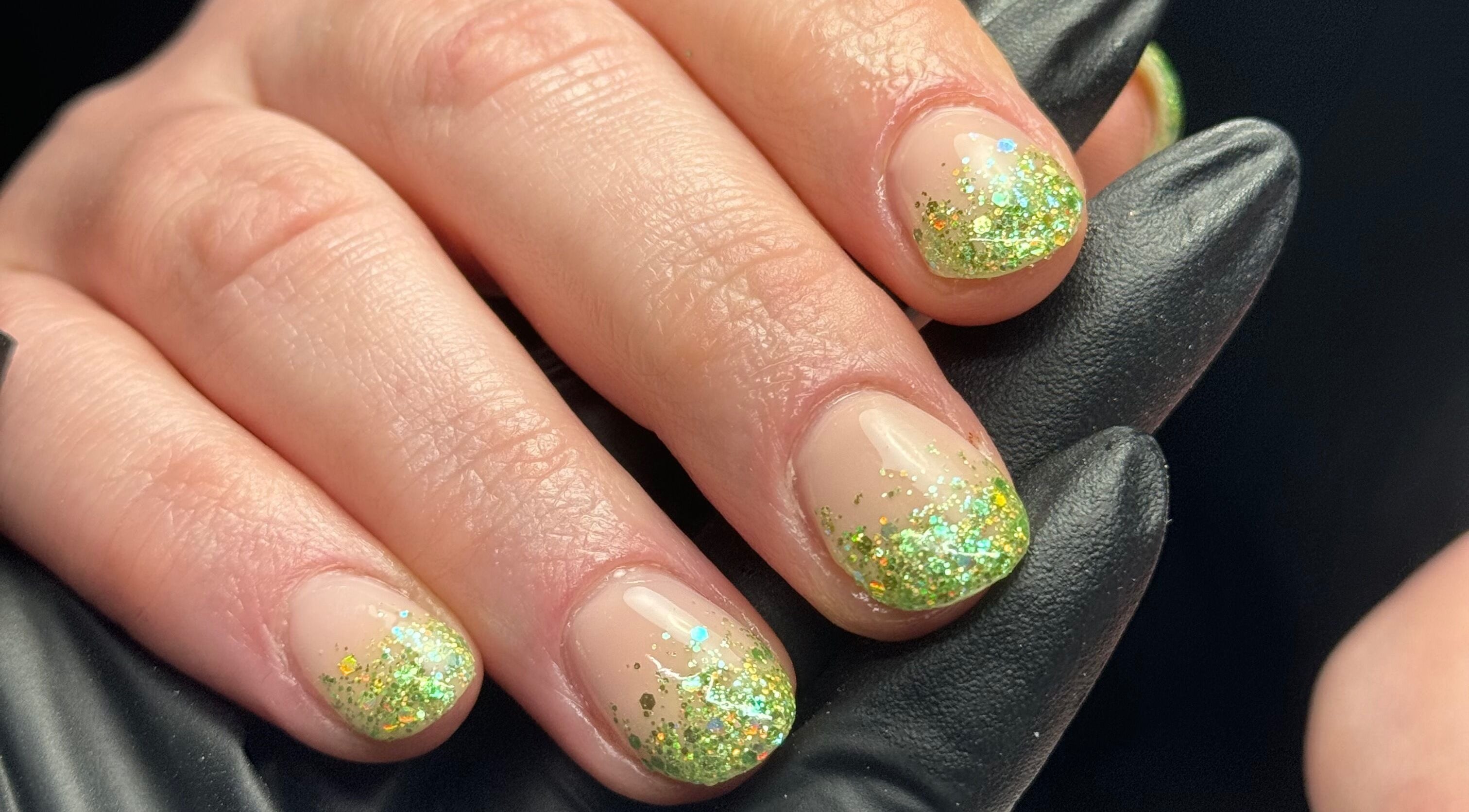 Glittering green nail art at Painted Nails X Charlotte in Wokingham, England, GB, showcasing elegant design.