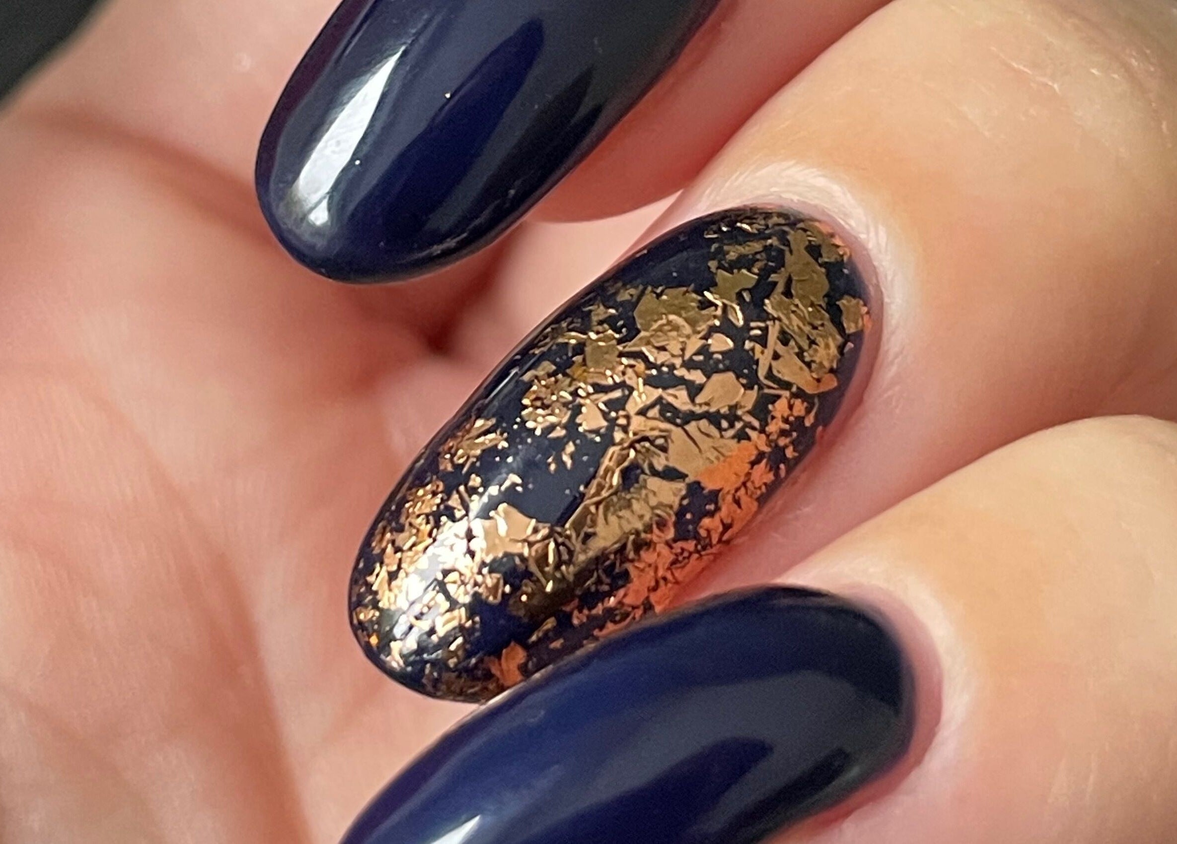 Elegant navy nails with gold flakes at Painted Nails X Charlotte, Wokingham, England, GB.