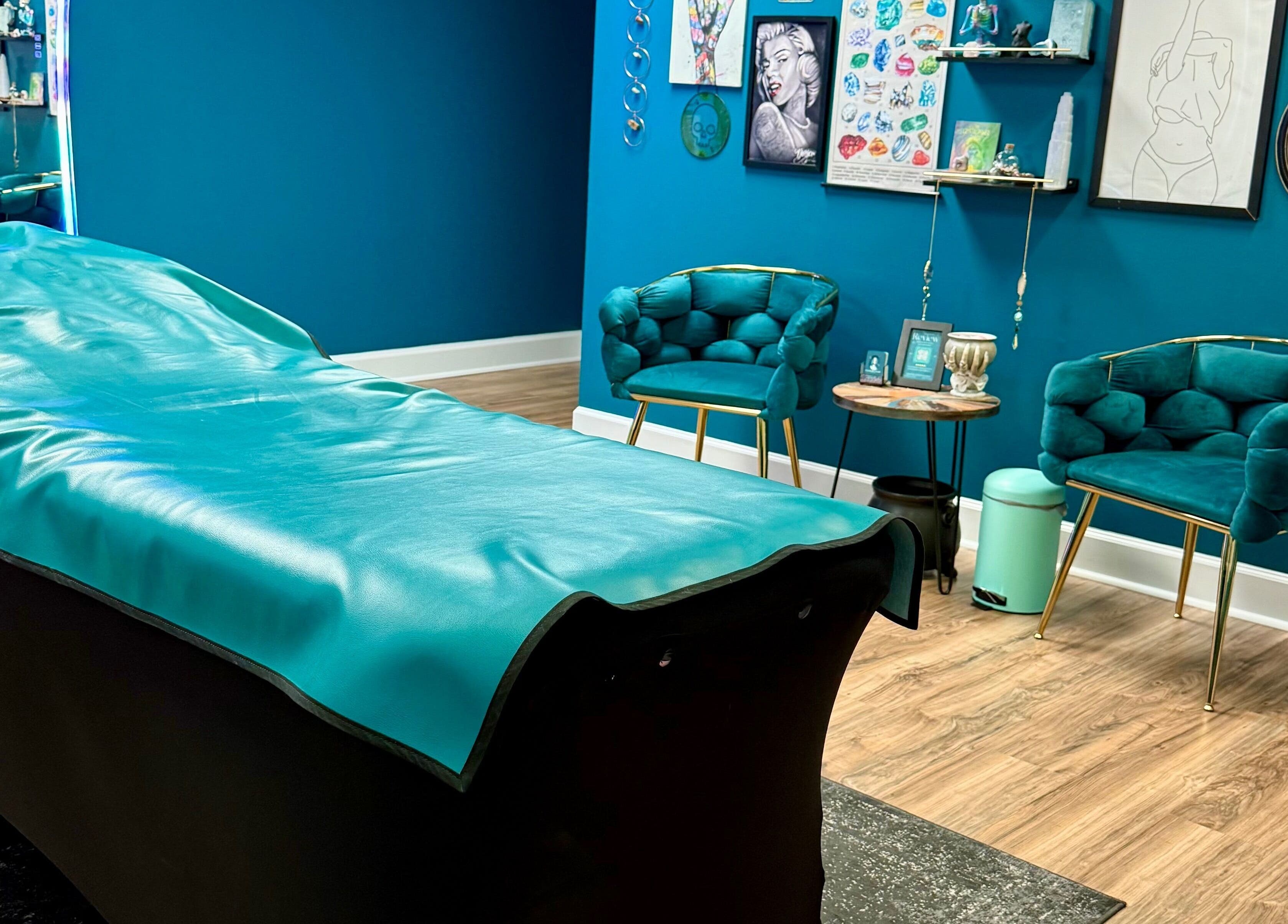 Relaxing wax room at Crystal Coven Waxing in Alexandria, Virginia, US, with teal tones and cozy seating.