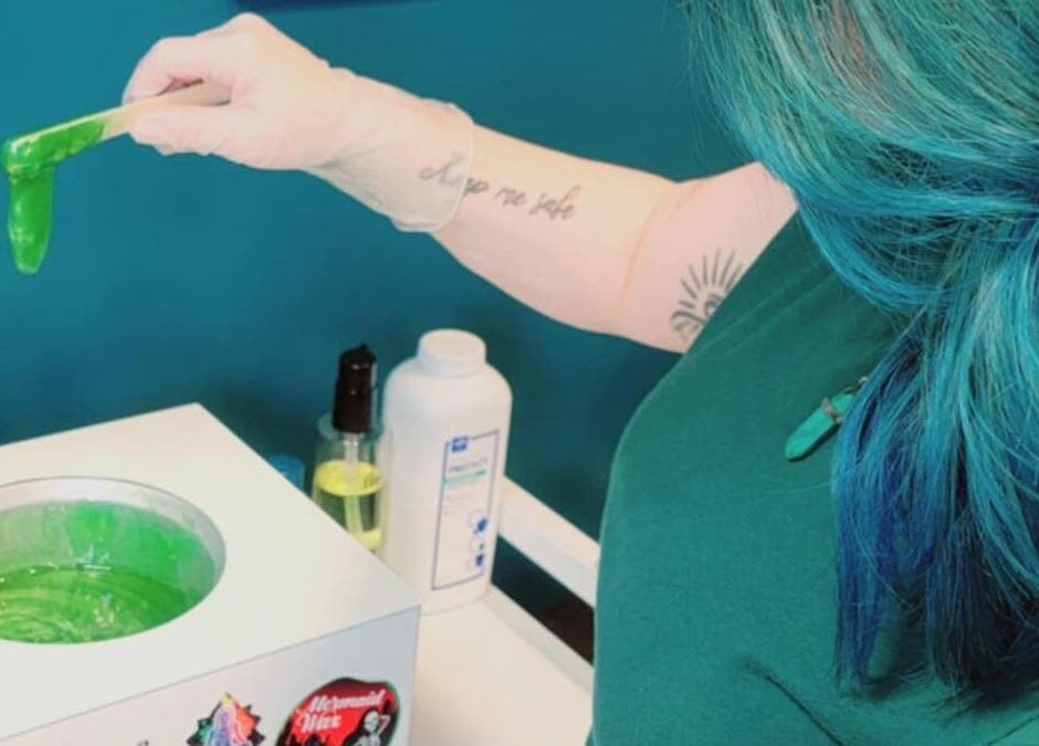 Crystal Coven Waxing professional applying green wax, Alexandria, Virginia, US spa service.