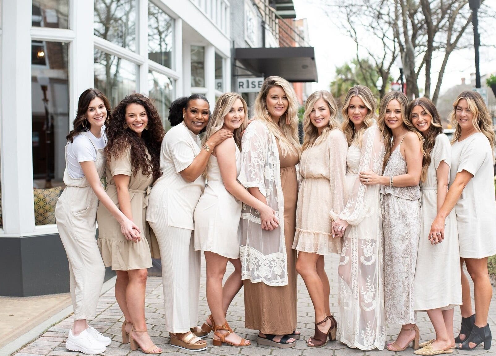 Team of stylists smiling outside Whimsy Salon, Valdosta, Georgia, US, showcasing salon's welcoming vibe.