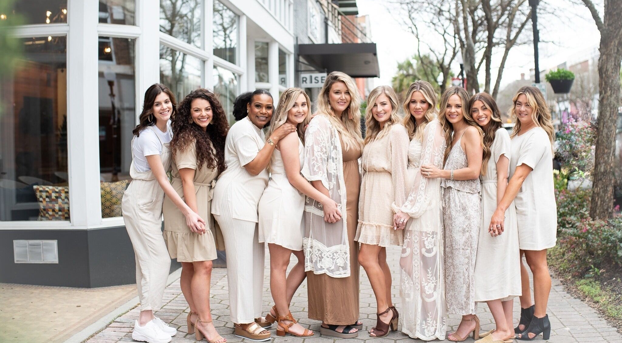 Team of stylists smiling outside Whimsy Salon, Valdosta, Georgia, US, showcasing salon's welcoming vibe.