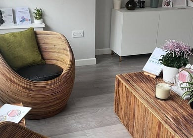 Inviting lounge area at Skinergy by Leona, Manchester, England, GB, featuring stylish rattan furniture and plants.