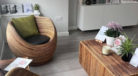 Inviting lounge area at Skinergy by Leona, Manchester, England, GB, featuring stylish rattan furniture and plants.