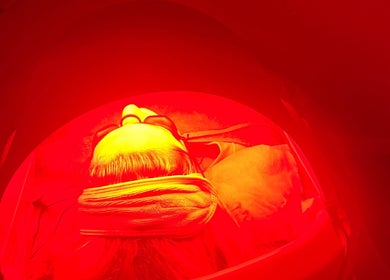LED therapy session at Skinergy by Leona, Manchester, England, GB with vibrant red light ambience.