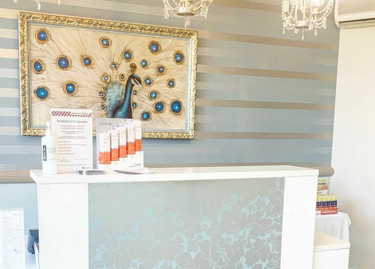 Reception desk at E-Sab Clinic, Benowa, Queensland, AU with peacock wall art.