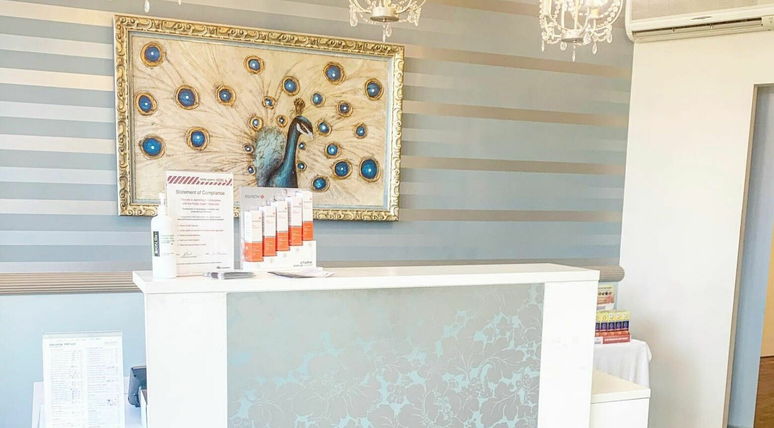 Reception desk at E-Sab Clinic, Benowa, Queensland, AU with peacock wall art.