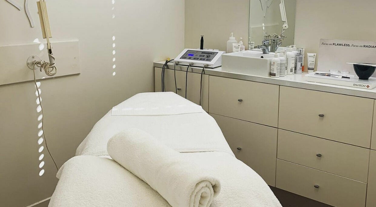 Tranquil treatment room at E-Sab Clinic, Benowa, Queensland, AU, with a pristine white bed and modern equipment.