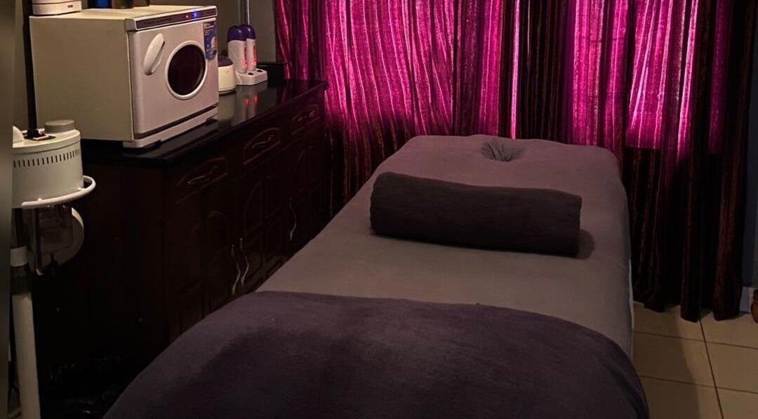 Luxurious massage room at Prestige Luxe Spa, Accra, Greater Accra Region, GH, featuring plush towels and ambient lighting.