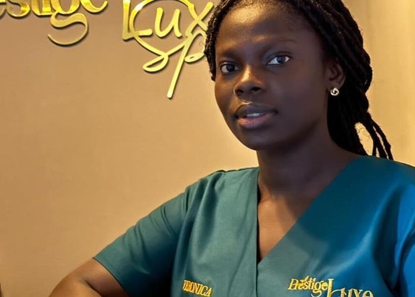 Receptionist at Prestige Luxe Spa, Accra, Greater Accra Region, GH, greets with a warm smile.