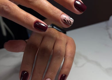 Stylish nail design at Beauty By Lid Nail Studio, Santa Clarita, California, US. Burgundy nails with unique accent.