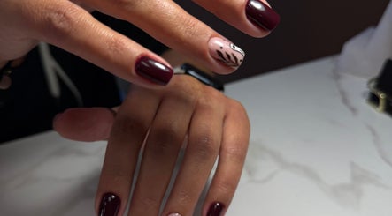 Stylish nail design at Beauty By Lid Nail Studio, Santa Clarita, California, US. Burgundy nails with unique accent.