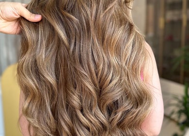 Beautiful wavy brown hair styled at Beauty By Lid Hair Salon in Santa Clarita, California, US.