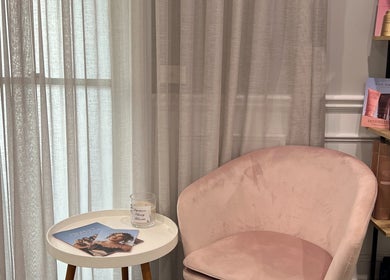 Elegant seating area with pink chair at Hair by Laura Marie in Camden, New South Wales, AU.