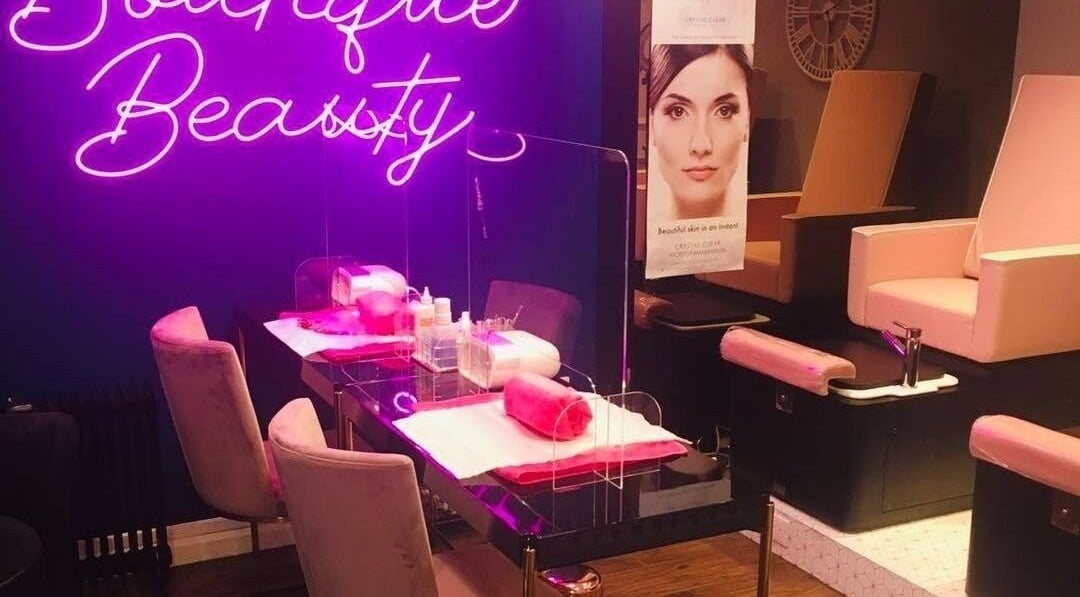 Lux lounge 373 in Aberdeen, Scotland with plush seating and a neon sign creating a welcoming ambiance.