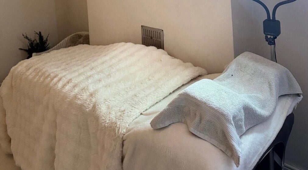 Luxurious treatment room at Larbella Beauty in London, England, GB, featuring a plush, fur-covered bed.