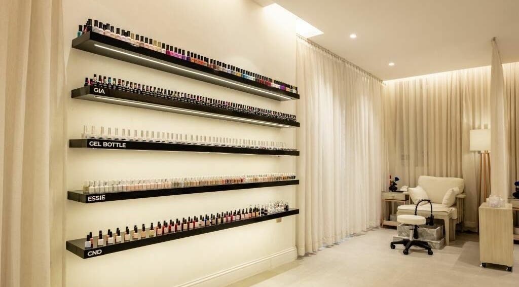 Nail polish display and cozy chair at Aya Salon, Riyadh, Riyadh Province, SA. Inviting beauty space.