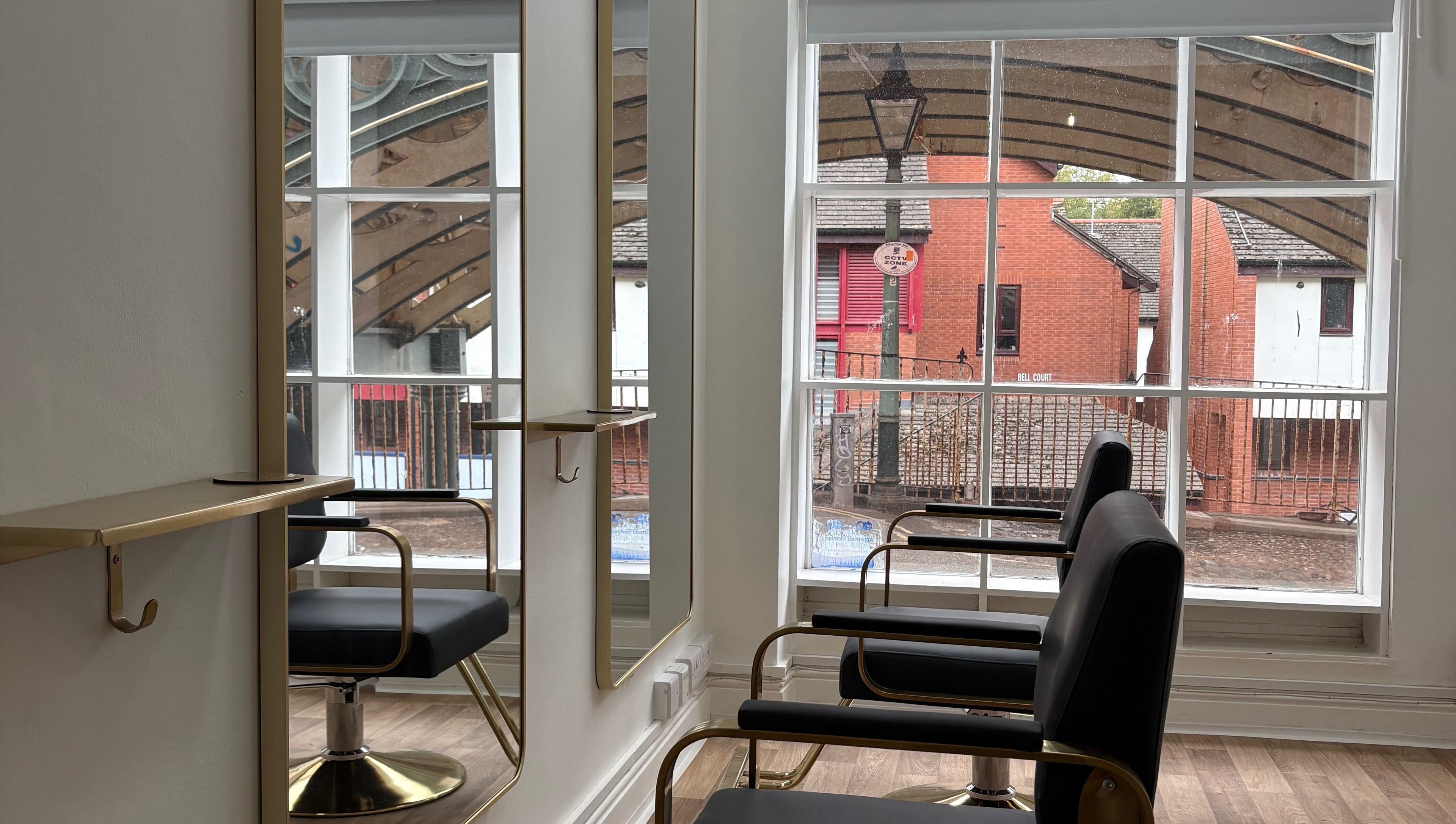Elegant salon chairs at 14a Lower North Street, Exeter, England, GB with large windows and bright interior.