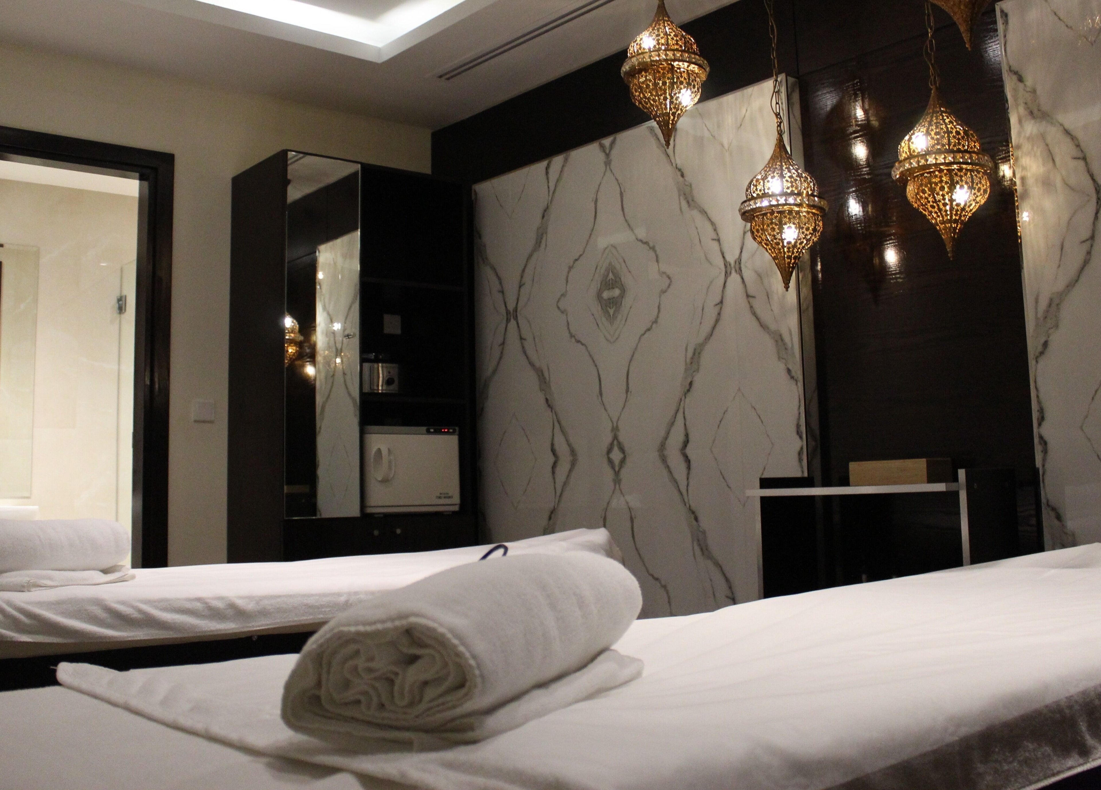 Elegant spa treatment room at DWS-Barcelo Al Jaddaf, Dubai, Dubai, AE featuring luxurious decor and plush towels.