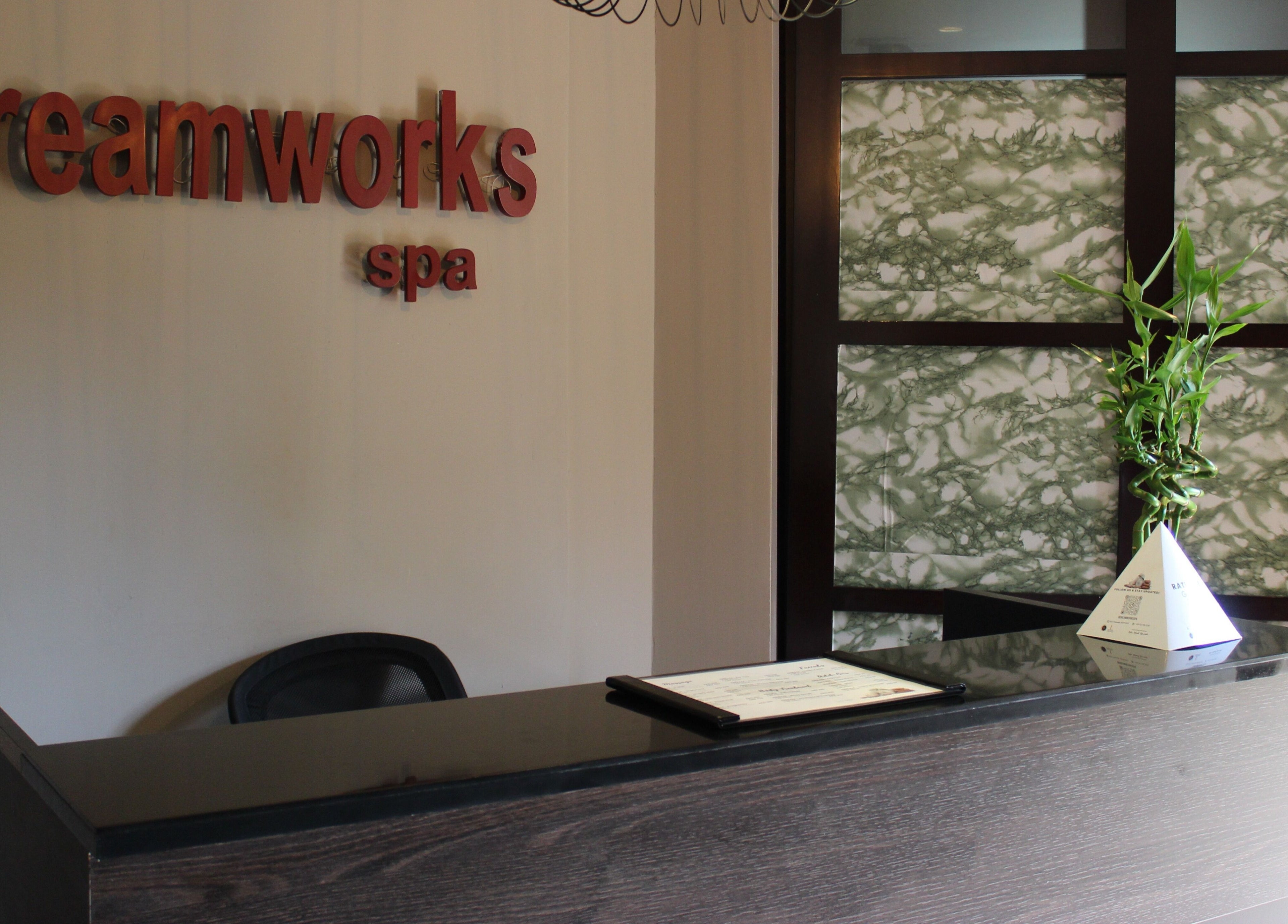 Elegant reception desk at DWS-Palm Jumeirah, Dubai, AE with bamboo decor, inviting atmosphere.