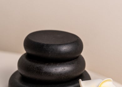 Stacked black massage stones at DWS-Marina Cascades, Dubai, Dubai, AE. Perfect for relaxation and wellness.