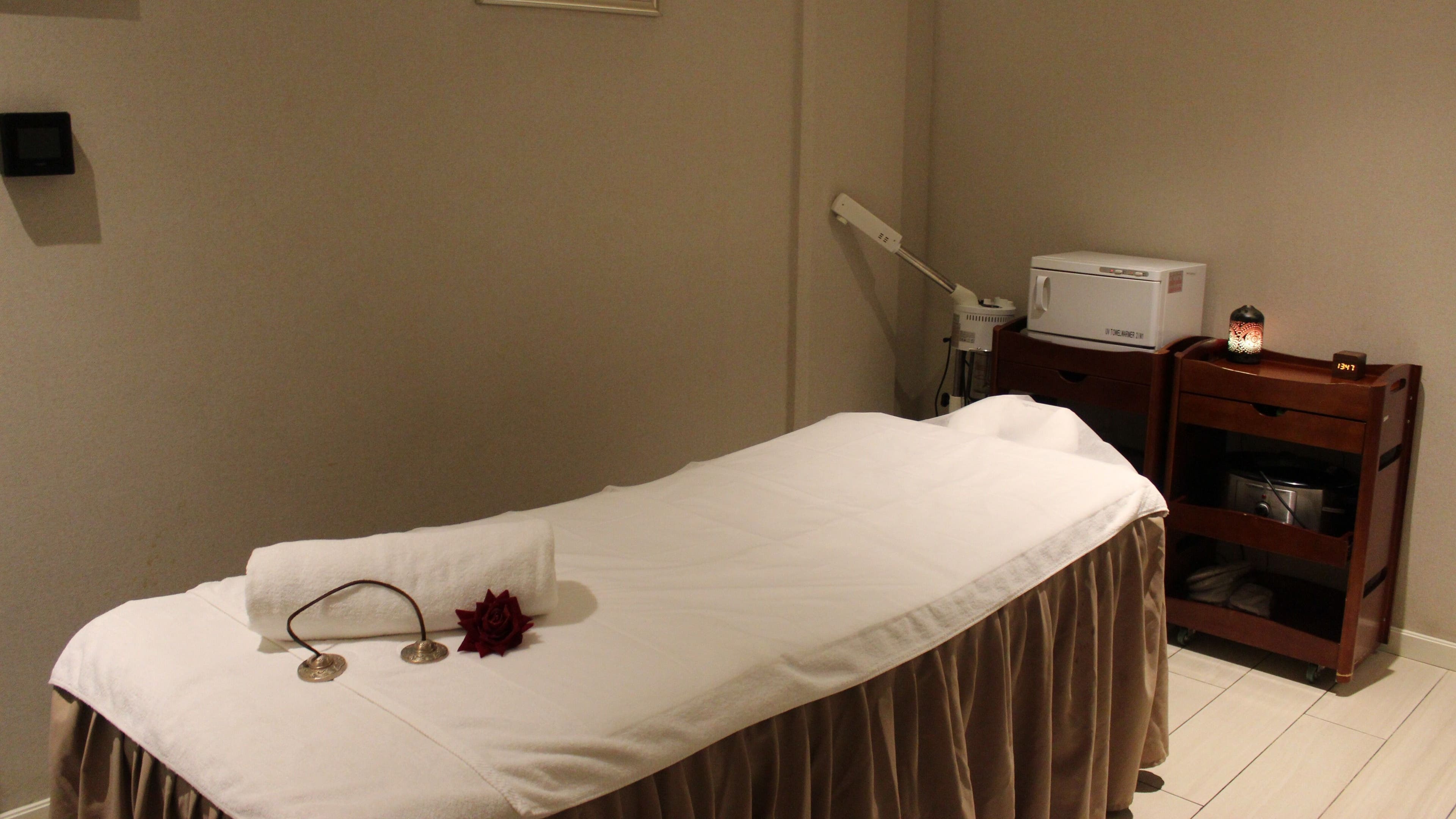 Relaxing spa treatment room at DWS-Aloft Hotel, Dubai, Dubai, AE with massage table and ambient lighting.