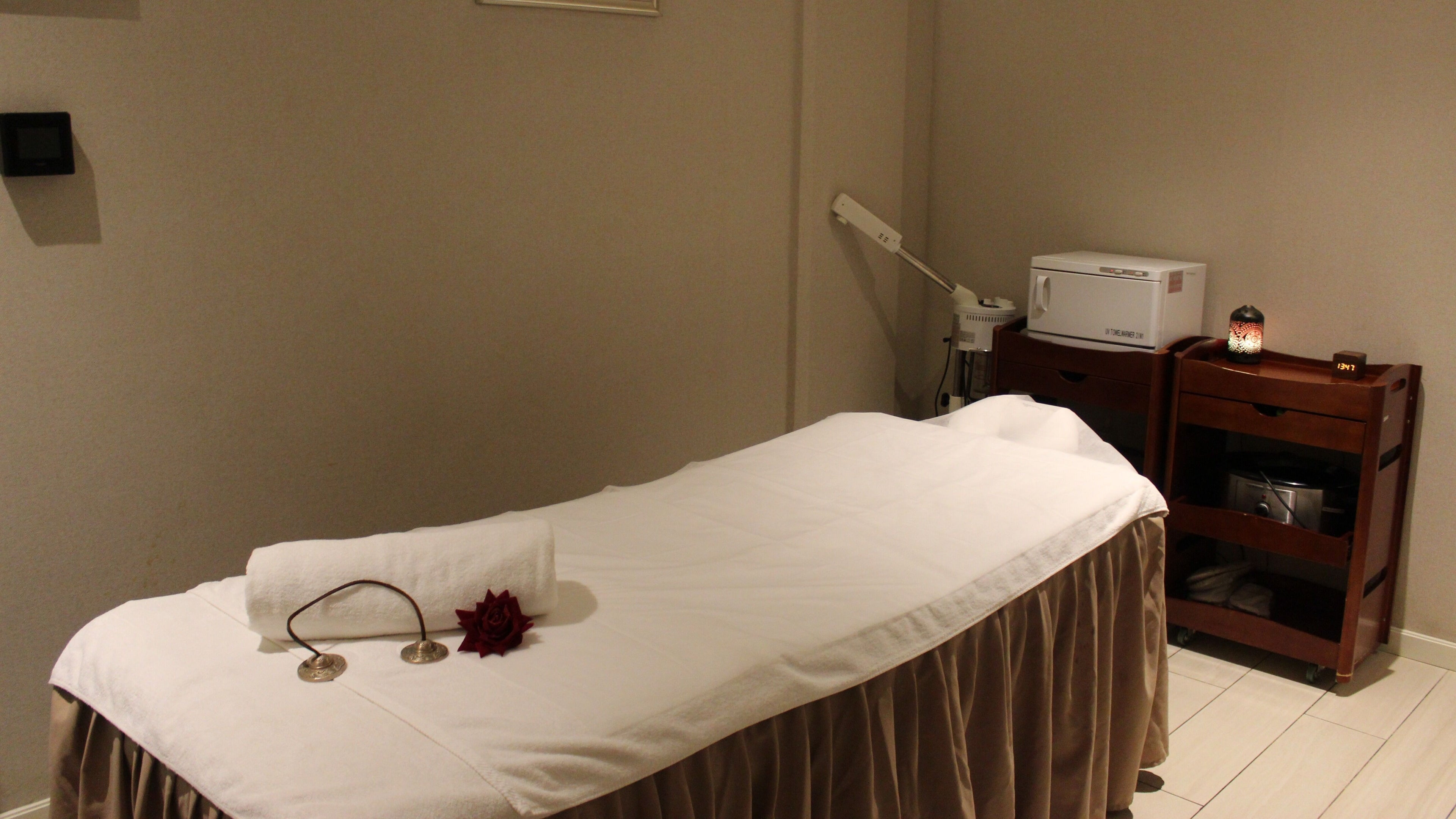 Relaxing spa treatment room at DWS-Aloft Hotel, Dubai, Dubai, AE with massage table and ambient lighting.