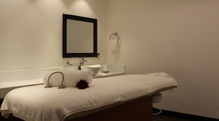 Luxurious spa room at DWS-Radisson Blu Waterfront, Dubai, Dubai, AE with massage table and soft lighting.