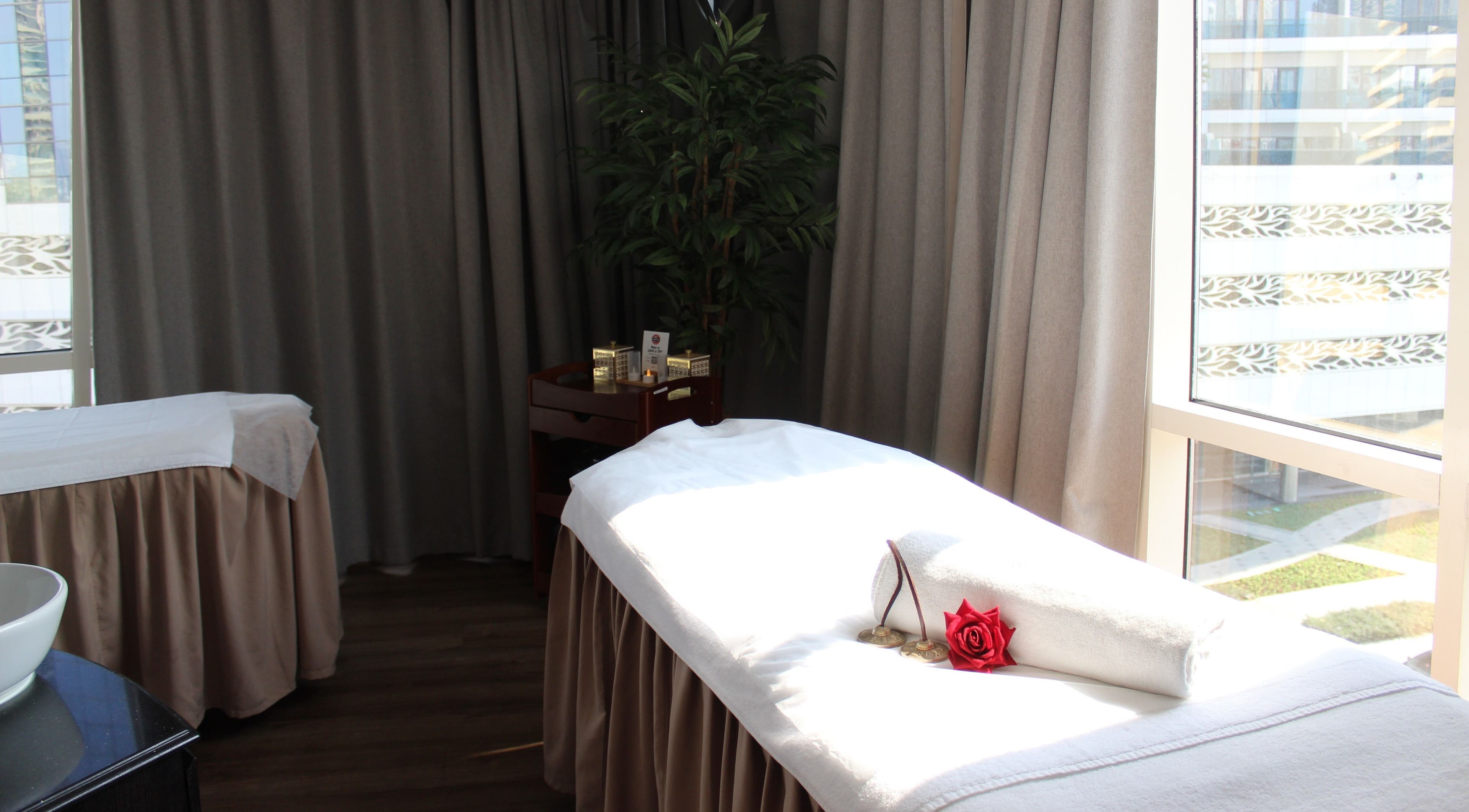 Relaxing spa treatment room at DWS-Radisson Canal View in Dubai, Dubai, AE, featuring a massage table.